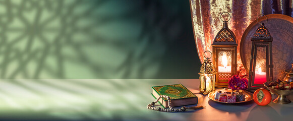 Iftar fast-breaking evening meal of Muslims in Ramadan at the time of adhan. Quran Book, Arabic lantern for Muslim holy month Ramazan Kareem. Decorative Holiday lamp © TSViPhoto