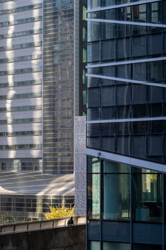 Modern architecture tower highrise of glass in urban Paris France La Defense shows corporate cityscape with clean lines and bright sky