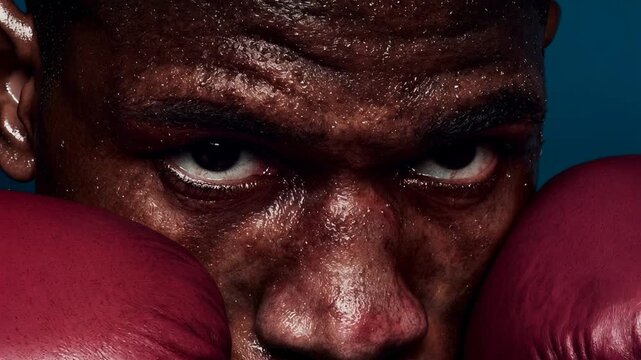 Intense closeup portrait of focused boxer with gloves raised showing determination strength resilience endurance and mental toughness before decisive fight