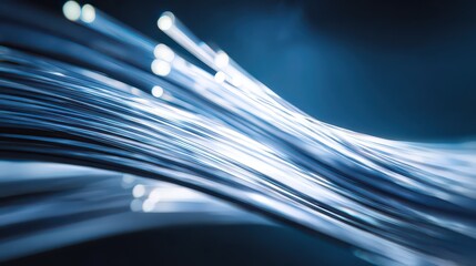 Fiber Optic Cables Glowing Blue on Dark Background Featuring Data Transmission for Telecommunications and High Speed Internet Technology