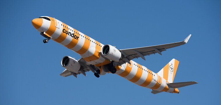 Tenerife, Spain january 26st, 2026. Airbus A321-271NX Condor (Yellow Sunshine Livery) airlines, flies in the blue sky. Takeoff at Tenerife Airport