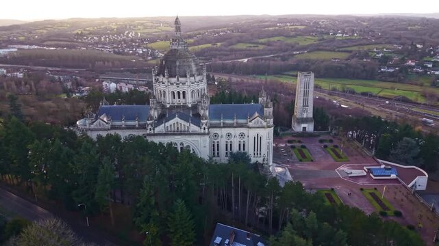 Drone slowly orbits the Basilica of Lisieux with town and countryside around