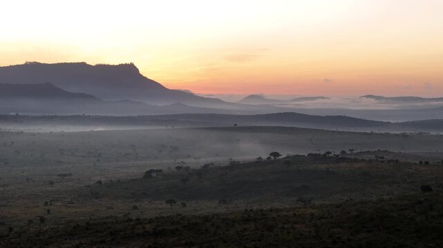 Sunrise over the Savannah in Kenya during a foggy morning.
