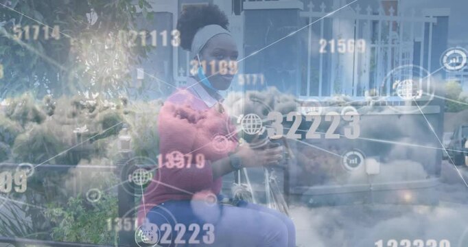 Network of digital icons and clouds against african american woman having a snack on the street