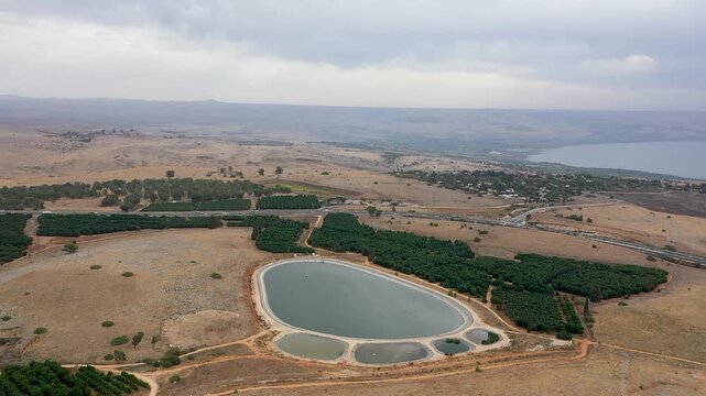 Aerial view of the unique water reservoir in the shape of a giant's footprint located at the Amiad Junction in the Upper Galilee overlooking the stunning Sea of ​​Galilee