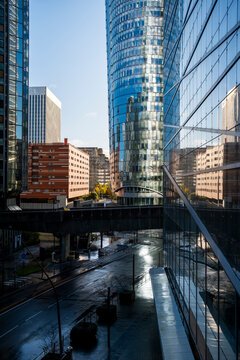 Business skyline architecture in urban Paris La Defense with modern reflection on glass towers and walkway leading through cityscape