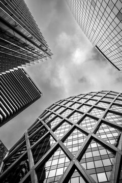 Monochrome perspective of modern glass facade skyscraper architecture rising over urban Paris La Defense financial district skyline