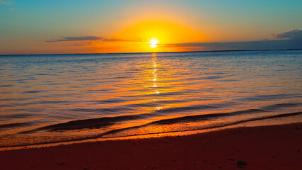 Fototapeta premium A breathtaking sunset or sunrise illuminates the ocean horizon and serene seascape