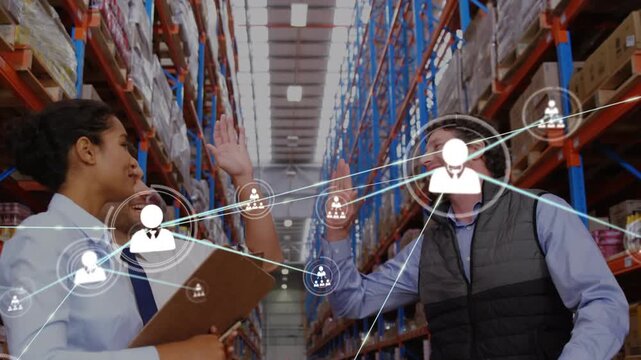Animation of network of profile icon over diverse male and female supervisors high fiving each other