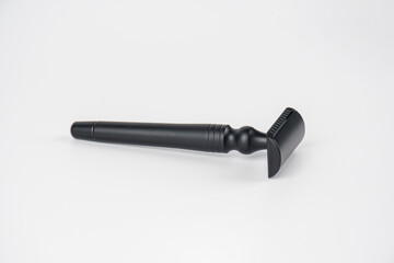 A fake black razor in hand against on white background.
