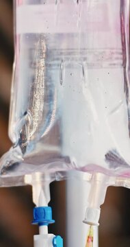 Closeup, IV drip or bag with medical treatment for chronic condition, illness or cure in hospital. Recovery, fluid or liquid medication with vitamin nutrition for immune booster or clinic supplement