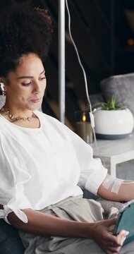 Infusion, relax and tablet with woman in drip lounge for injection of saline solution or vitamins. App, earphones and streaming with person in wellness clinic for healing, hydration or iv therapy