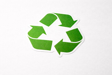 Green recycling symbol isolated on white background. Environmental protection, sustainability and waste management concept.