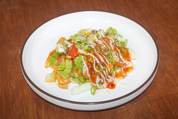 Delicious Loaded French Fries Topped with Fresh Salad and Savory Sauces