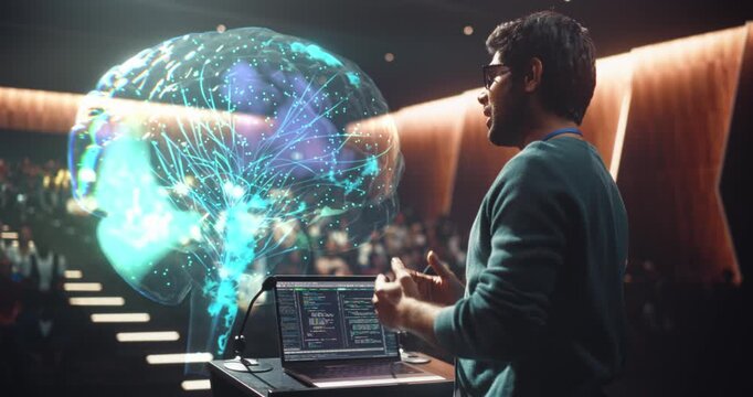 Lecturer  Delivers a University Computer Science Keynote at the Podium, Gesturing Using Brain Hologram. Laptop Programming Code Manipulates AI and Neural network Software Concepts, Teaching Audience