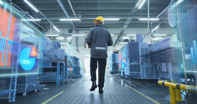 Factory Engineer Walks Through Production Factory as Holographic Overlays Machines, Data Grids, Visualizing Industry 4.0 Monitoring, Predictive Maintenance, Smart Manufacturing Analytics 