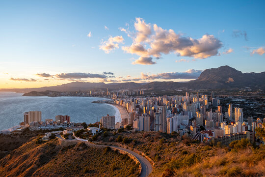 Aerial sunset panorama of coastline skyline and sea with mountains landscape travel scene in benidorm spain from high viewpoint mediterranean coast