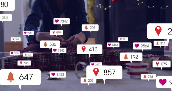 Animation of social media icons with numbers over woman packing presents