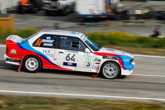 San Marino: 2010 09 01 Rally free event BMW E30 rally car sliding through a smoky corner during a motorsport exhibition
