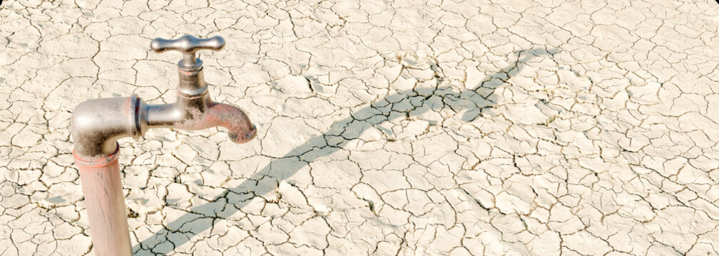 Outside water tap rusted over with strong shadows from the mid day sun on cracked drought covered ground 3d render