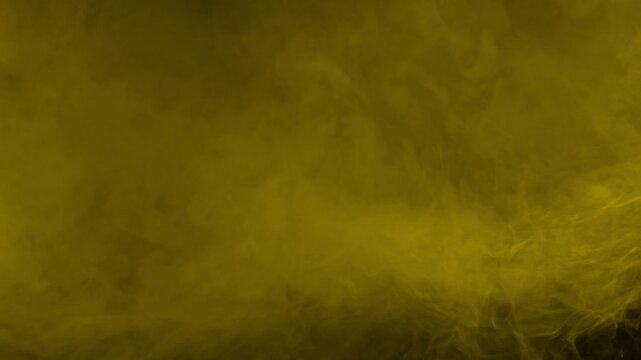 Dense golden yellow fog filling the screen. Isolated on black background, ideal for compositing