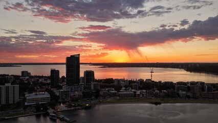 Naklejka premium Sunset over Perth City CBD, Western Australia – aerial view of skyline, modern skyscrapers, urban cityscape and golden evening light