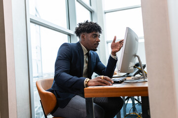 Fototapeta premium African American businessman working at office desk.