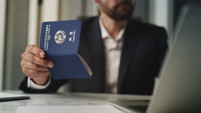 Customs officer checking North Korean passport data online for consular service