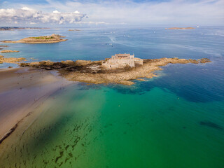 Wide aerial view of Fort National at high tide, showing its stone walls surrounded by the Atlantic, highlighting its coastal defense and historic maritime presence in Brittany.

