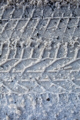 Fototapeta premium Winter Tire Tracks Texture on Icy Road Surface