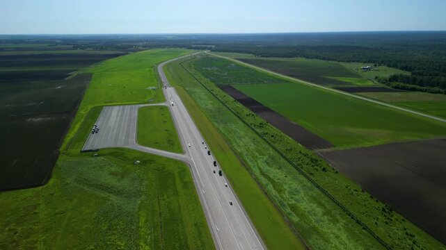 Scenic Rural Roadway, Rolling Landscape With Winding Highway, Elevated View Of Lush Countryside With Curved Roads, Aerial Perspective Showing Meandering Road Through Vibrant Greenery And Forests