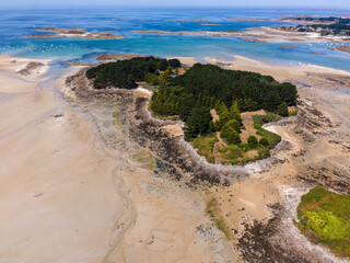 Aerial view of &Icirc;le Aval in Brittany, France, showcasing its lush green landscape surrounded by deep blue Atlantic waters, highlighting the island&rsquo;s natural beauty and coastal isolation.

