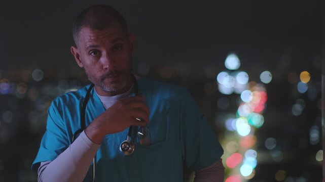 Exhausted medical professional in scrubs feeling stressed during an overnight shift at the hospital