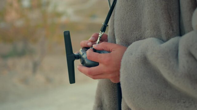 Man wearing virtual reality or FPV goggles while controlling a drone outdoors. Modern technology and innovation concept showing immersive drone piloting, aerial control, and future tech lifestyle.