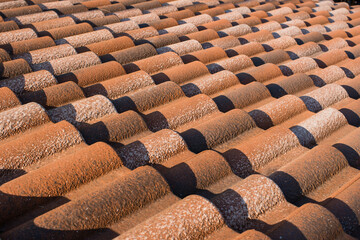 Close-up of metal wavy roofing tiles under bright sunlight © PhotOleh