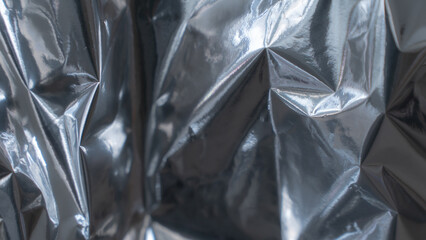 Smooth dark metallic foil texture with glossy reflective surface