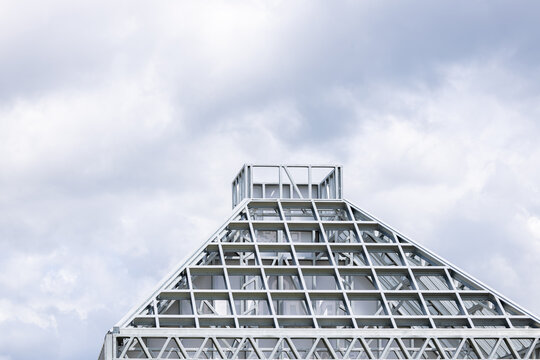 Close-up of a modern galvanized light steel frame LSF construction. Architectural details of roof trusses and wall framing against a blue sky. A sustainable and efficient building material.