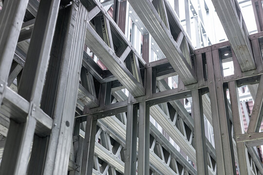 Medium shot of interior steel stud framing showcasing lightweight precise metal framework for modern wall construction
