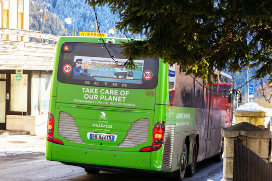 Cortina, Italy - January 27, 2026: Green Setra bus with environmental message parked on a snowy street in the Dolomites, showcasing sustainable transportation in a mountainous region