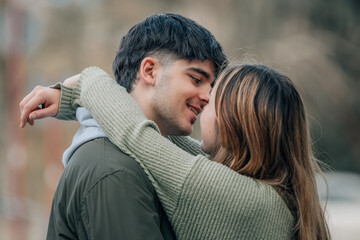 young caucasian couple hugging in love on the street, love