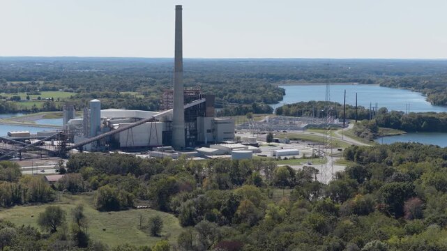 Flint Creek Power Plant With Smokestack, Conveyors, And Industrial Buildings On The Banks Of SWEPCO Lake In Gentry, Arkansas. drone sideways shot