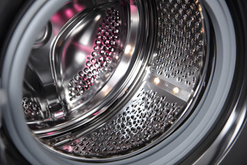 Modern washing machine drum with shiny interior showing advanced cleaning technology in action