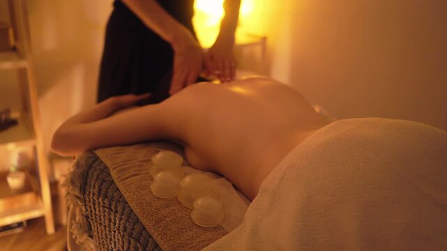 Therapist delivers rhythmic back therapy, Client receives firm deep tissue massage in calm studio