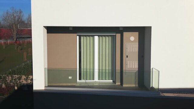 Close-up view of a modern window and balcony facade in a contemporary residential building. Clean architectural lines, minimal design and sustainable housing concept under daylight.