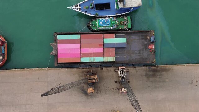 A dynamic aerial view of a bustling global shipping port, facilitating the delivery of diverse multimodal cargo.