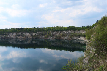Obraz premium Zalew Zakrzówek - an artificial reservoir in Krakow in Zakrzówek. It was created in 1992 after the flooding of an old limestone quarry. It consists of two reservoirs, connected by an isthmus