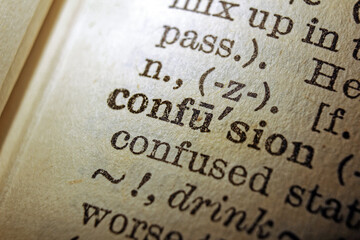 Word confusion printed on dictionary page, macro close up