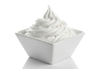 Fluffy whipped cream swirl in white square bowl isolated on white background