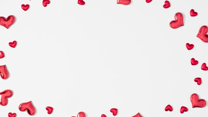 Valentine's Day background with scattered small red hearts around the edges, creating a frame. The...