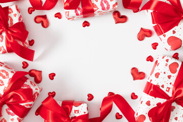 Romantic Valentine's Day background with gift boxes decorated with red bows and hearts, with empty space in the center and decorative red and white hearts. Valentine's Day gifts.